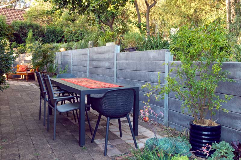 Grey retaining wall paved outdoor dining area in Tamworth NSW
