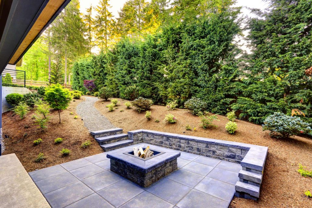 Outdoor fireplace with grey paving